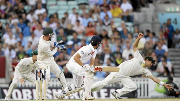 Close shave: Alastair Cook narrowly avoids being caught at slip by Shane Watson.