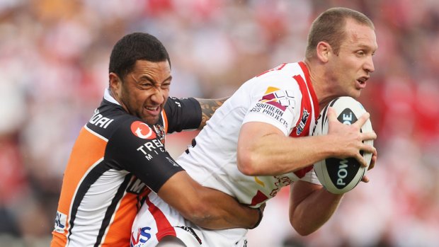 Wests Tigers' Benji Marshall tackles Ben Hornby of the Dragons.