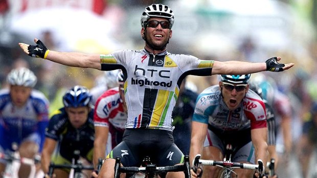 Mark Cavendish celebrates as he crosses the finish line to claim victory in the 11th stage of the Tour de France, ahead of Germany's Andre Greipel (right).
