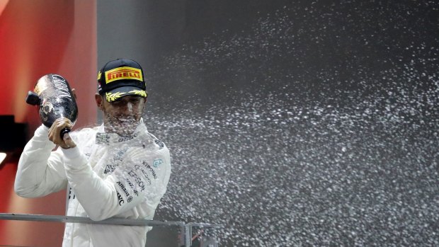 Lewis Hamilton celebrates on the podium.