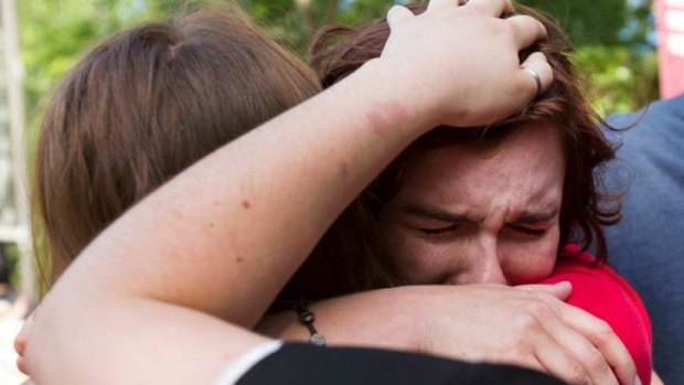 Seattle Pacific University students hug after a gunmen killed one man before being disarmed. 