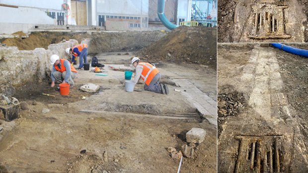 Workers at the excavation site yesterday - mid-19th century drain, right, was among the treasures found.