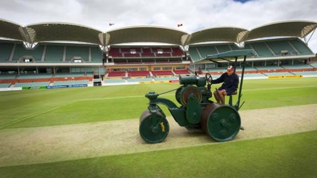 The new curator of the Adelaide Oval, Damian Hough, rolls out his first Test pitch yesterday.
