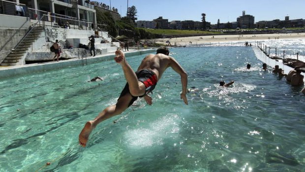 Crystal clear: Josh Kennedy takes the plunge at Bondi on Monday during a recovery session.