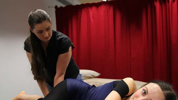 Amber Scott gets treated by a physiotherapist after rehearsal.