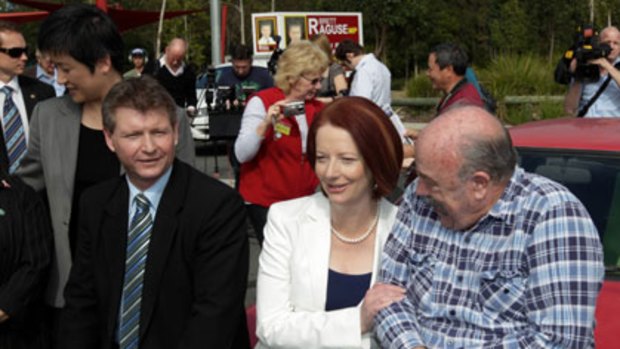 Zoom, zoom ... MP Brett Raguse and Julia Gillard meet Colin Foot, right, owner of a 1987 Celica.