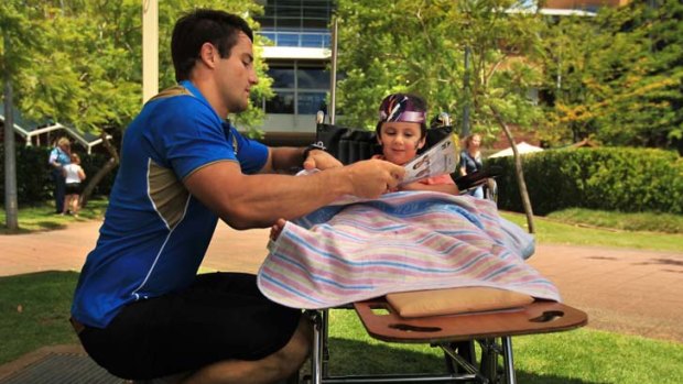 Hospital visit &#8230; Cooper Cronk reads with Matthew McLeod.