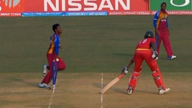 Tricky: Keemo Paul runs out Zimbabwean batsman Richard Ngarava.