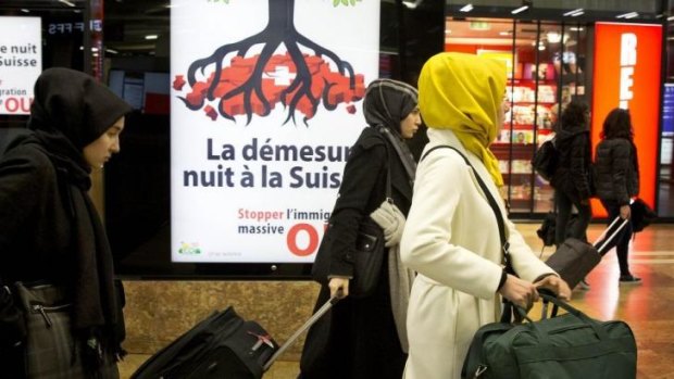 Backlash: Women covered in veils pass an election poster from the nationalist Swiss People's Party.
