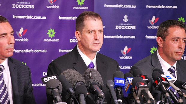 Newly-appointed Fremantle coach Ross Lyon (centre) says he didn't stab Mark Harvey in the back.