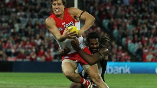 Pecking order: Kurt Tippett is tackled by Harry O'Brien.