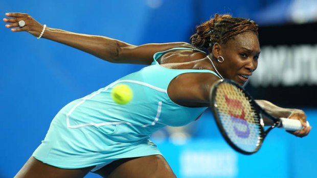 Venus Williams of the USA plays a backhand to Mathilde Johansson of France in her Hopman Cup singles match.