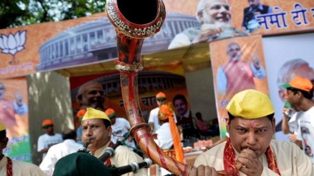 Clarion call: a horn is blown in front of the Delhi HQ of the Bharatiya Janata Party, which has won a historic victory in India's general election.