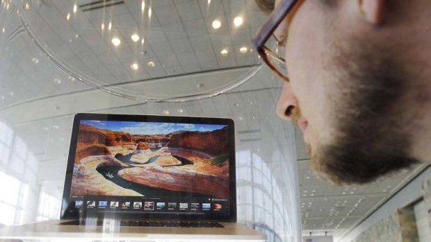 An attendee looks at the new MacBook Pro on display at the Apple Developers Conference in San Francisco,