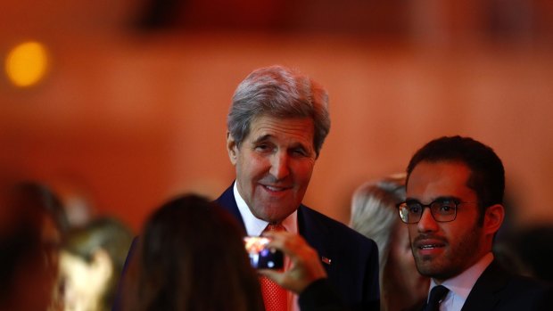 US Secretary of State John Kerry poses for a photo as he arrives at conference centre on Saturday.
