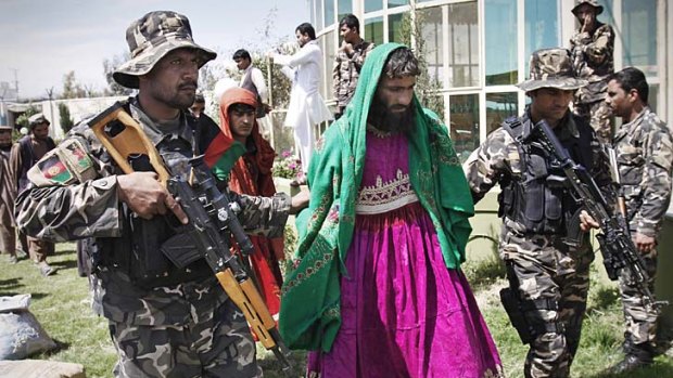 Taliban militants disguised as women are paraded in Laghman province. Shootings by militants of coalition forces have led to security changes.