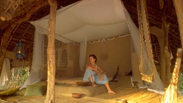 Escapism ... the "rooms" have one wall, a mosquito net and clay pot for drinking water.