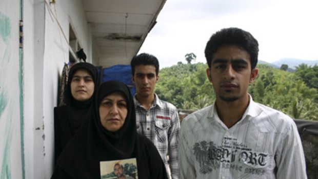 The Hashimi family: (from left) daughter Zahra, mother Nahle Abd Uan, and sons Qasseme and Hossein. Nahle holds a picture of her husband.