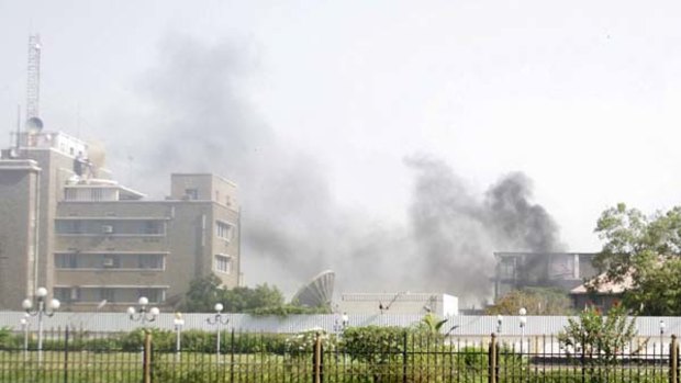 Smoke rises from a police compound in the southern Yemeni port city of Aden after gunmen attacked a police headquarters.