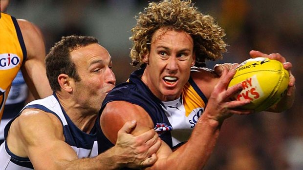 Brad Ottens tackles Matt Priddis of the Eagles during Friday's game.