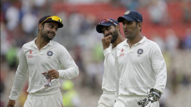 India captain and wicketkeeper Mahendra Singh Dhoni, right.