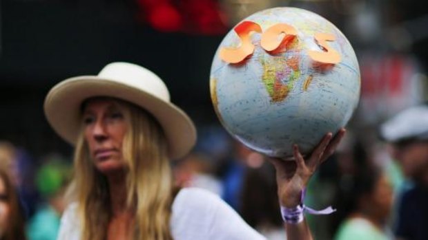 A woman takes part in a march against climate change in New York on Sunday.