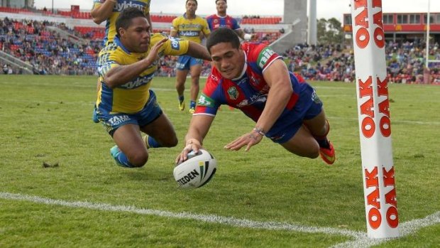 Rookie on the fly: Knights youngster Sione Mata'utia scores in the corner against Parramatta.