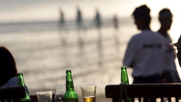 Japanese tourists enjoy a sunset beer at the Menega Fish Cafe in Jimbaran Bay.