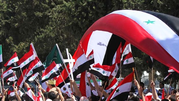 Protesters carry Syrian flags during a demonstration calling on Syria's President Bashar Assad to step down.