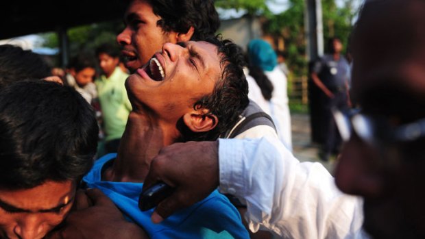 A Bangladeshi youth reacts after finding a relative among the dead.