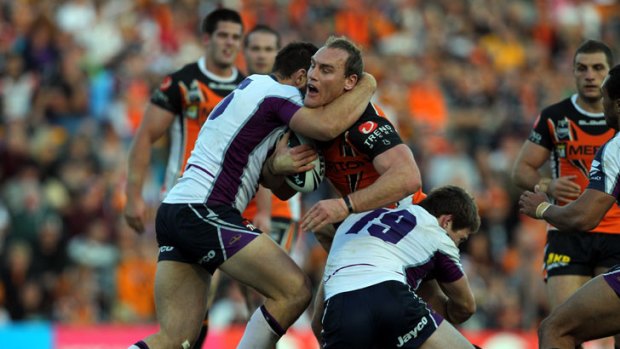 Tag team ... Storm defenders halt Gareth Ellis at Leichardt Oval yesterday. Melbourne's tackling will again come under scrutiny.