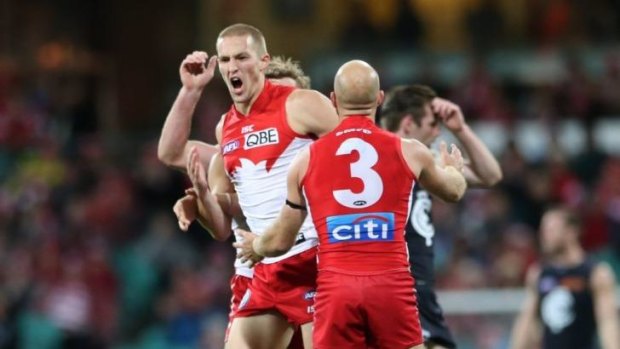 Whooping it up: Sam Reid enjoys booting a major against the Blues.