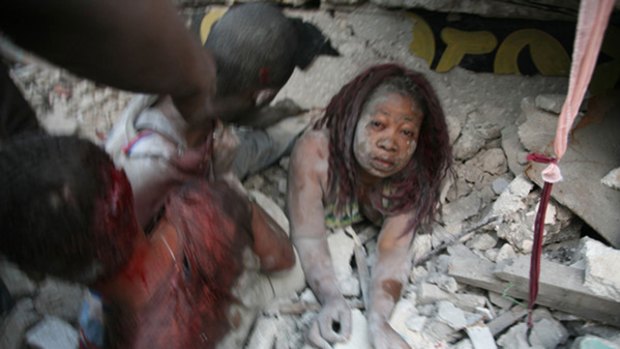 Lucky escape ... a Haitian woman is pulled from the rubble in Port-au-Prince after the quake struck.