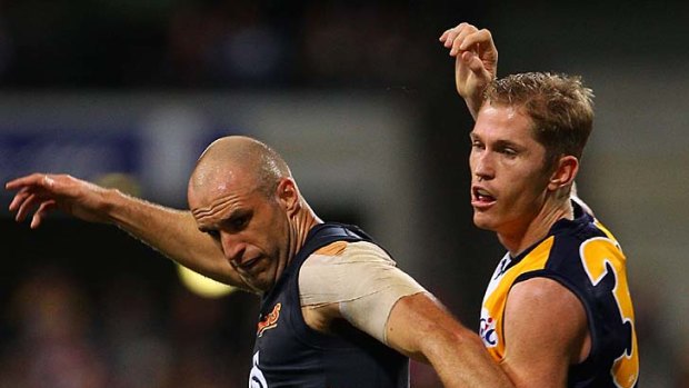 Adam Selwood and Chris Judd contest the ball during the first semi-final.