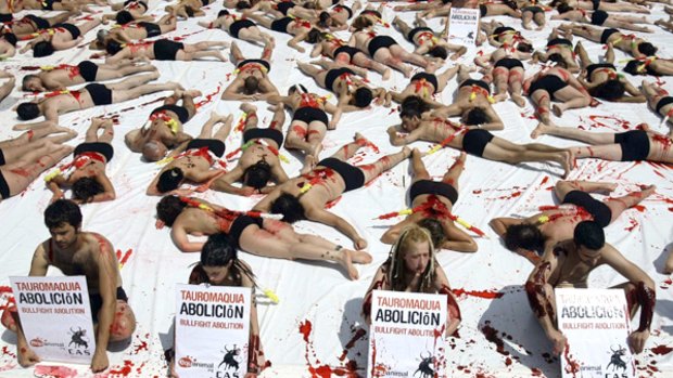 Animal rights activists covered in fake blood from the group Igualdad Animal (Animal Equality) protest during a demonstration calling for the abolition of bullfights outside Madrid's Las Ventas bullring.