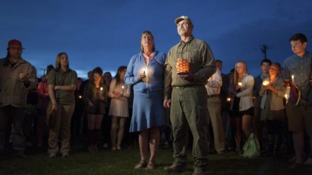 'This is not us': Kate Walker and Randy Smith, the host family of slain exchange student Diren Dede, attend a vigil for him in Missoula, Montana, on May 2.