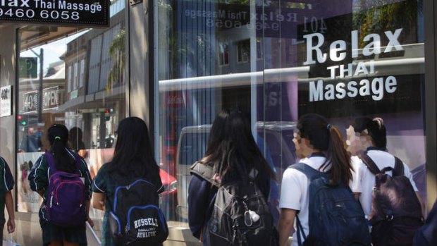 Schoolchildren walk past the Relax Thai Massage parlour at Crows Nest.