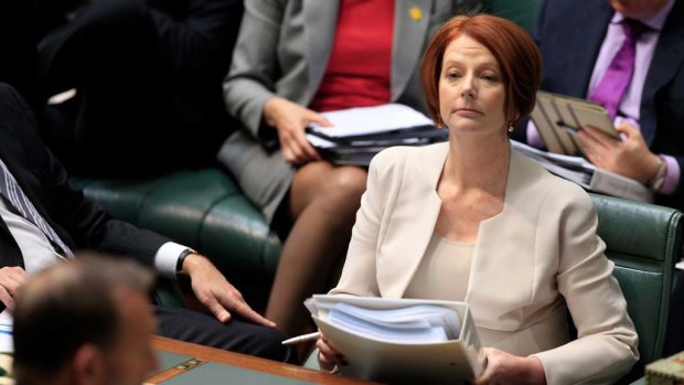 Prime Minister Julia Gillard listens to Opposition Leader Tony Abbott attempt to move a censure motion against her during question time.