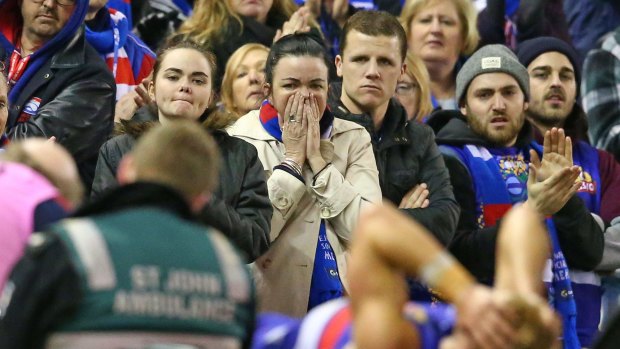 Bulldogs fans react as Mitch Wallis of the Bulldogs leaves the field injured.