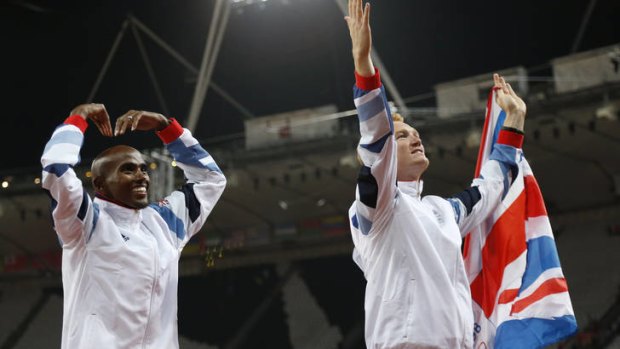 Victory ... Mo Farah, left, and Greg Rutherford salute the crowd after both won gold.
