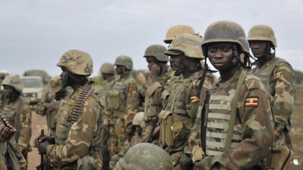Fighting al Shabaab ... Ugandan soldiers, serving in the African Union Mission in Somalia (AMISOM),  prepare to sweep the town of Bulamareer, in the Lower Shabelle region of Somalia.