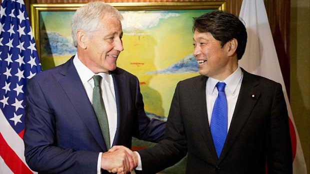 Backing Japan's plans in helping maintain security in Asia: US Defence Secretary Chuck Hagel, left, shakes hands with Japanese Defence Minister Itsunori Onodera at a security forum in Singapore.