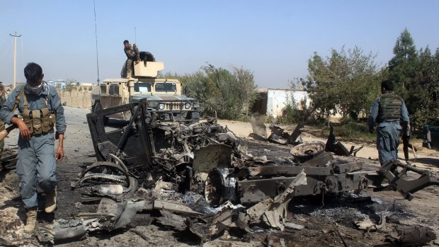 Afghan security forces inspect the site of a US air strike in Kunduz city, north of Kabul, on Friday.