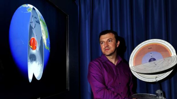 More like rocket science ... Associate Professor Hrvoje Tkalcic with an image of the Earth's inner core rotation and a model of the Earth with seismic waves.