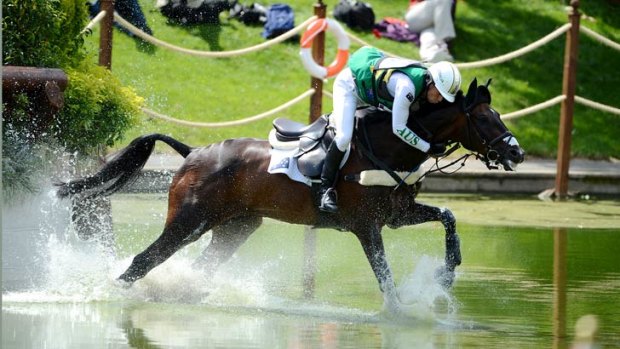 Australia's Sam Griffiths slips forwards on Happy Times during the cross country event at the London Olympics.