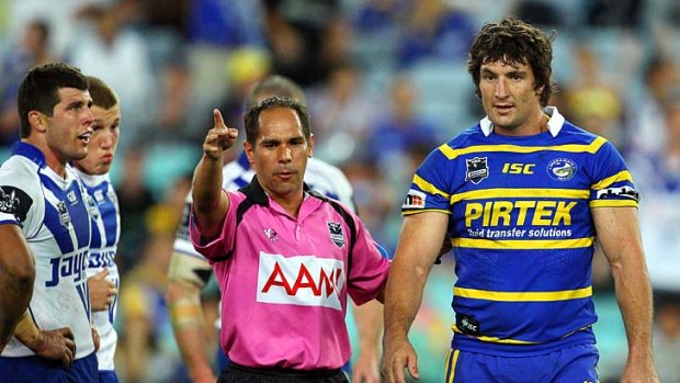 ‘‘He’s just a grub. I’ve been niggled by better’’ ... Parramatta captain Nathan Hindmarsh is sent off as Mick Ennis looks on.