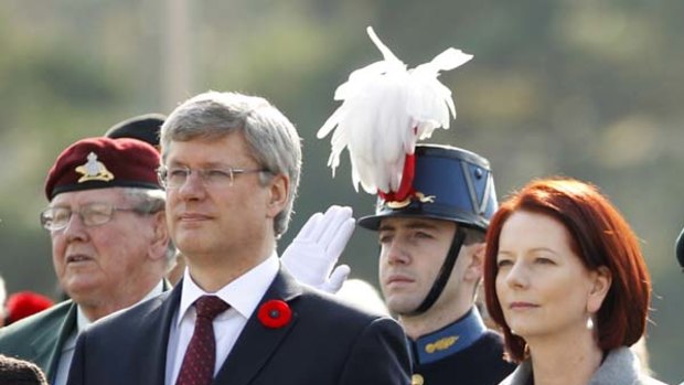 Canada's Prime Minister Stephen Harper and Australia's Prime Minister Julia Gillard   stand during two minutes of silence as they visit The War Memorial of Korea in Seoul.