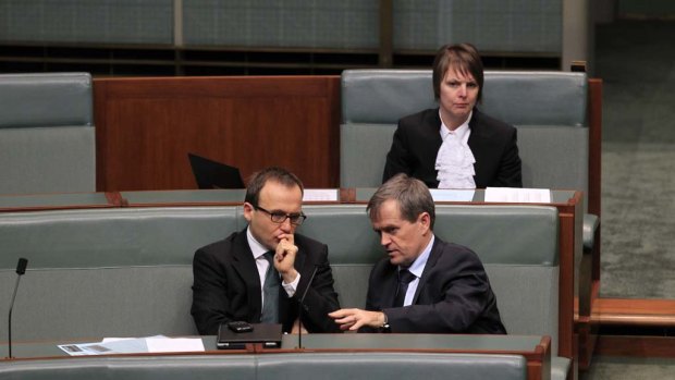 Greens MP Adam Bandt and Workplace Minister Bill Shorten talk during question time this afternoon.