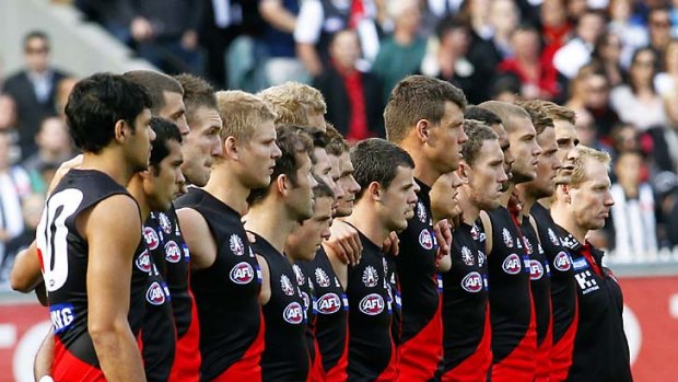 That was then... the Essendon team lines up with coach Matthew Knights before the 2010 Anzac Day fixture against Collingwood.