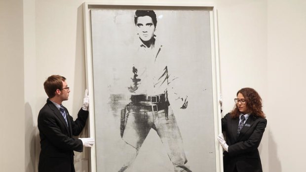 Andy Warhol’s portrait of Elvis Presley is auctioned at Sotheby's in New York City.